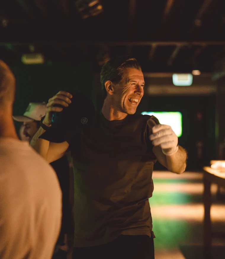 Dean Dewhirst laughing with members at GolfSpace
