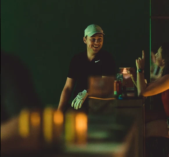 Members sharing a laugh at the GolfSpace bar